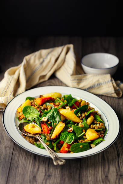 healthy vegan roasted vegetable, spinach, and lentils salad - dieting front view vertical lifestyles imagens e fotografias de stock