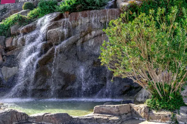 Photo of Fountain stylized as a waterfall from a cliff on the embankment of  Alanya Marina Yat Limani (Turkey)