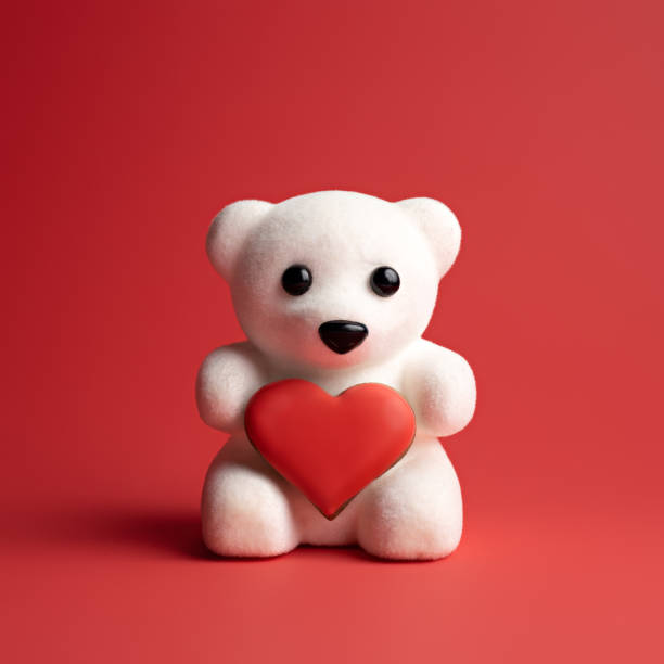 istock Valentine's day card made with white teddy bear holding heart on red background 1293863389
