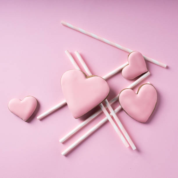 istock Glazed heart shaped cookies for Valentine's day on pink background 1293863393