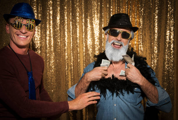 istock Two men taking funny photos in photo booth 1293863656