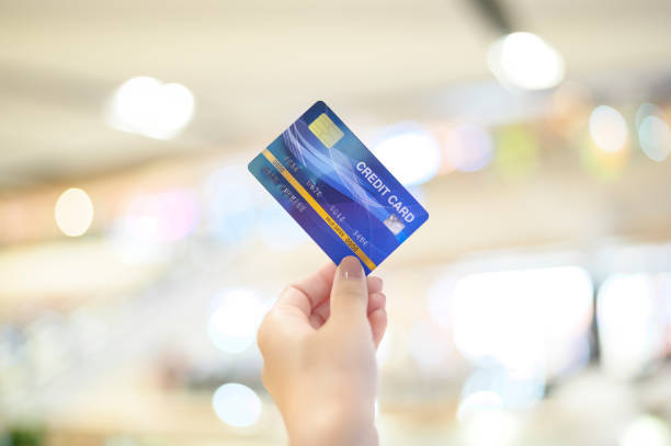 istock Close up hand using credit card in mall background 1293864630