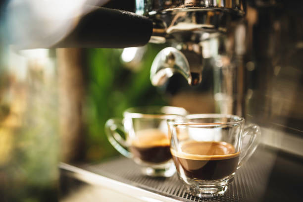 istock two cups of espresso being poured from an espresso machine 1293872417