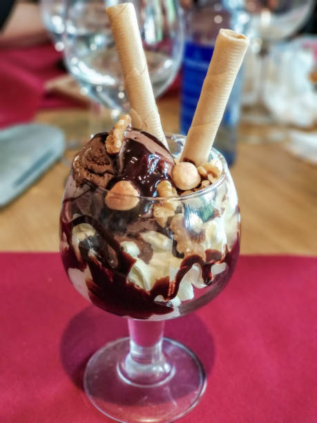 istock Ice cream cup with cream, wafers and nuts 1293873475