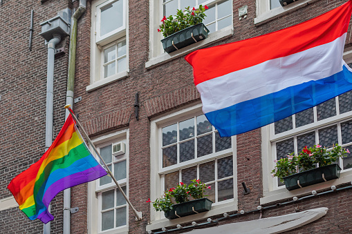 Netherlands and Rainbow Pride Flags at Building in Amsterdam