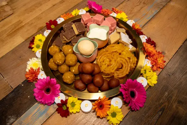A trey of delicious Indian sweet treats on a wooden work top