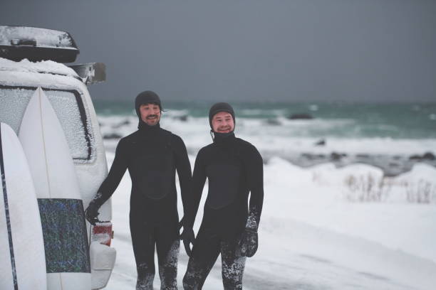 istock Arctic surfers in wetsuit after surfing by minivan 1293878024