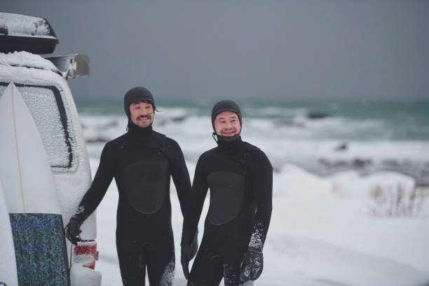istock Arctic surfers in wetsuit after surfing by minivan 1293878123