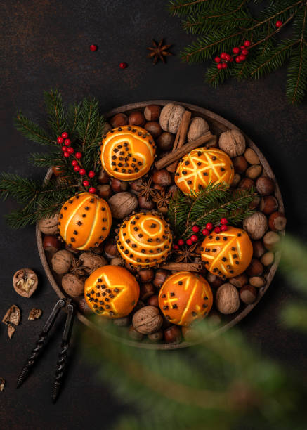 Top view of clove orange pomander balls with different motifs. Top view of clove orange pomander balls with different motifs. Homemade Christmas or New Year decoration concept. scent container stock pictures, royalty-free photos & images