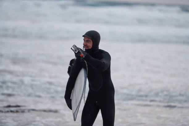 istock Arctic surfer going by beach after surfing 1293878312