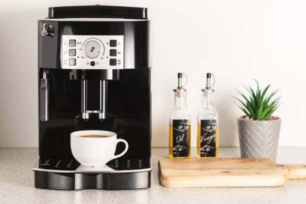 istock Modern espresso coffee machine with a cup in interior of kitchen closeup. 1293879141