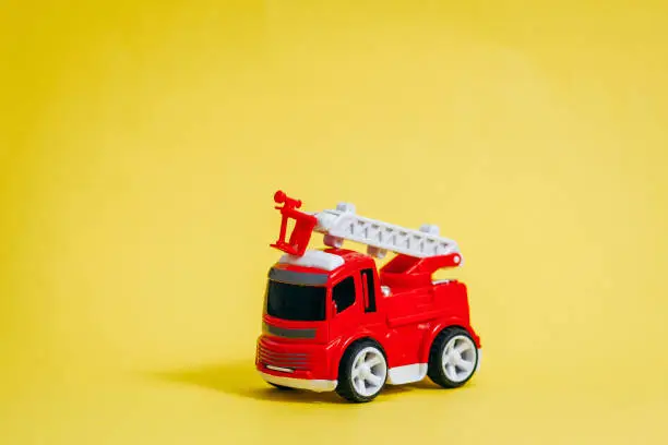 Photo of Red fire engine on yellow background