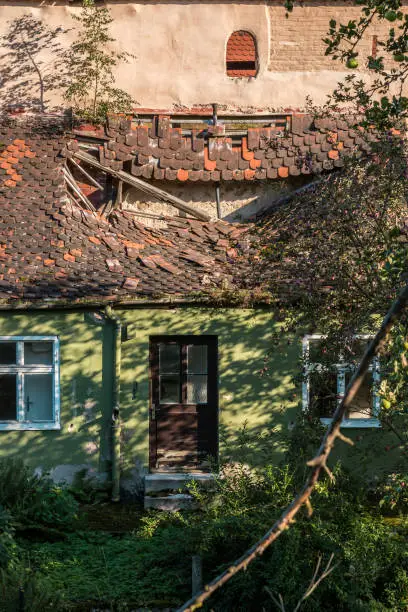 Broken roof of an old house near the city wall