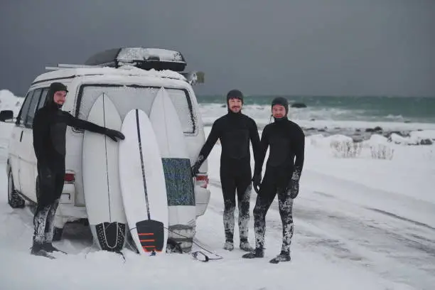 Photo of Arctic surfers in wetsuit after surfing by minivan