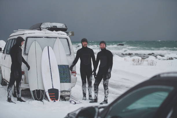 istock Arctic surfers in wetsuit after surfing by minivan 1293882282