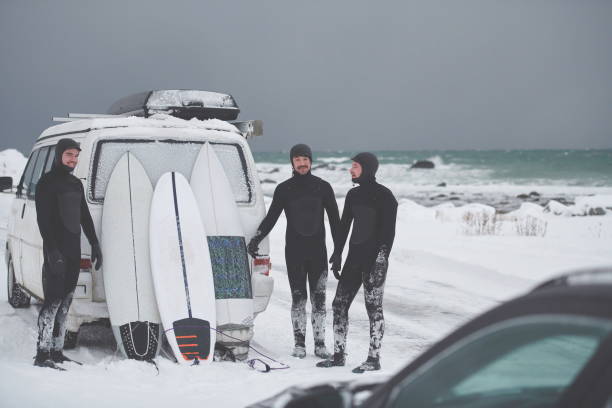 istock Arctic surfers in wetsuit after surfing by minivan 1293882891