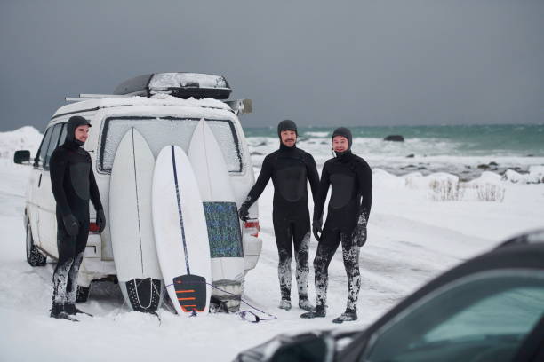 istock Arctic surfers in wetsuit after surfing by minivan 1293883847
