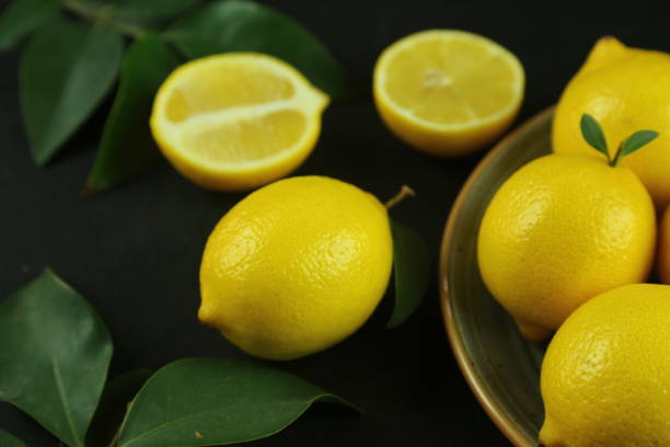istock Group of lemons with leaves, isolated on background 1293885767