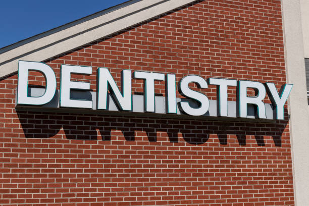 istock Dentist office exterior with white text and brick background. 1293887492