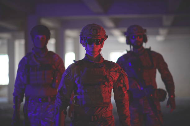 soldier squad team walking in urban environment colored lightis