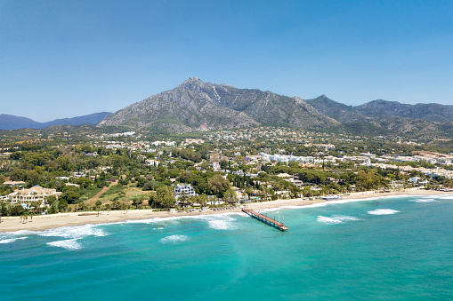 Beautiful and unique aerial perspective of luxury and exclusive area of Marbella, golden mile beach, Puente Romano Bridge. Luxury Clubs, Urbanisation in the most expensive area of Marbella. Mountain