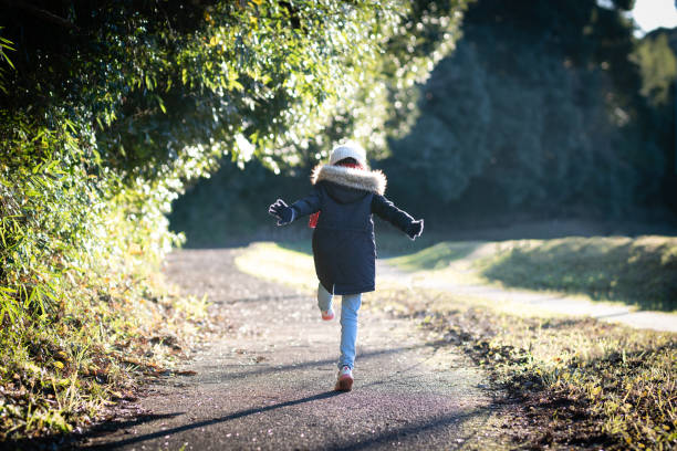 a child who walks along the path - healthy lifestyle nature sports shoe childhood imagens e fotografias de stock