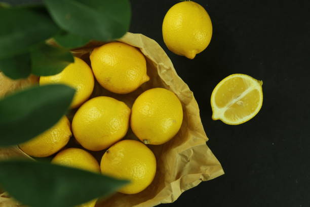 istock Group of lemons with leaves, isolated on background 1293889497