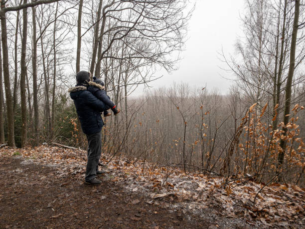 istock Man with baby on shoulders standing on viewpoint 1293891159