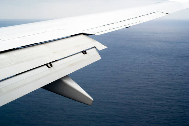 Airplane flying over the ocean preparing for landing on Bermuda