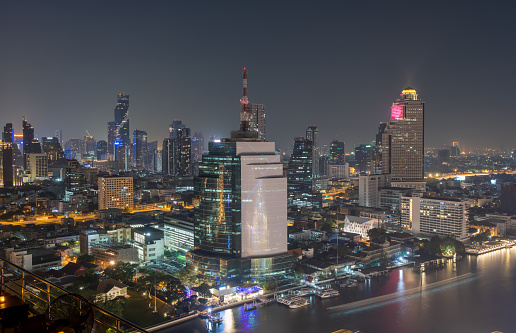 Aerial view of colorful lighting from building along Chaophraya River on night, Thailand