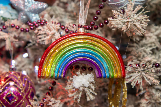A Christmas ornament in the Shape of a rainbow on a festive Christmas tree stock photo