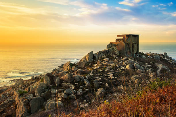Old and abandoned military coastal bunker in Silleiro Cape at sunset