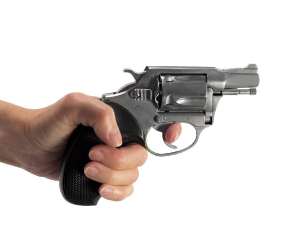 istock womens hand holding pistol 1293899798