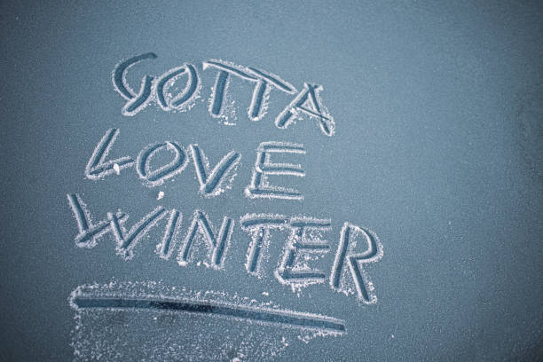 istock 'Gotta Love Winter' handwritten on a frosty car windshield 1293902364