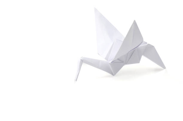 istock Origami crane isolated on white background 1293905487