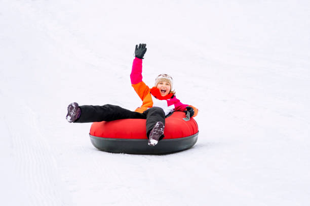istock Girl on Snow Tubes Downhill 1293910921