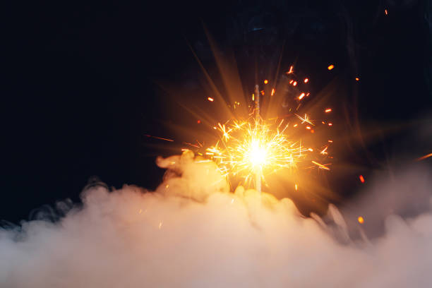 istock fire sparkler in dense smoke, abstract Christmas firework background 1293911779