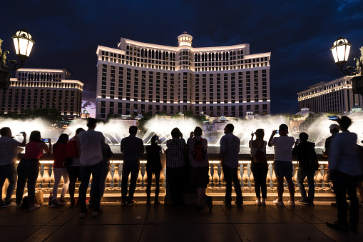 Las Vegas, USA - Sep 23, 2019: People watching the free Bellagio water show at twilight on the Strip early in the night.
