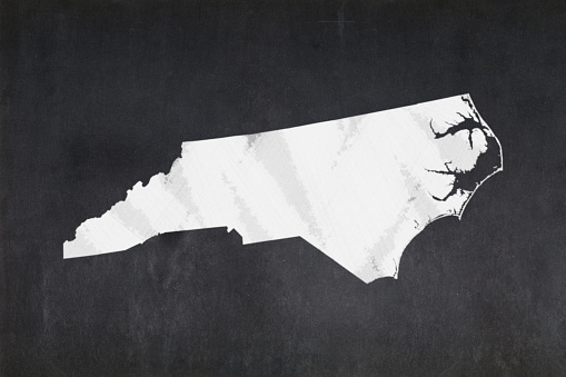 Blackboard with a the map of the State of North Carolina (USA) drawn in the middle.
