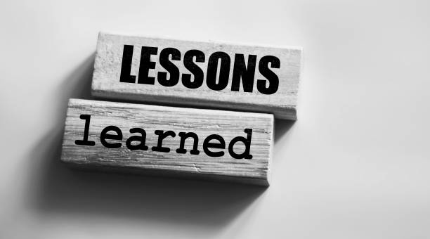 istock Lessons learned text on Wood blocks on pink. Business education concept. 1293917662