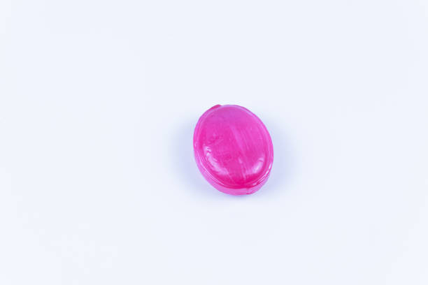 istock one pink sweet caramel candy lies on a white background 1293924539