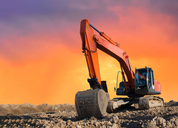 istock Excavator working on earthmoving at open pit mining on amazing sunset background 1293926952