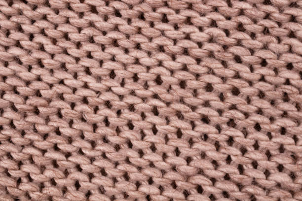 istock Wrong side rhythmically arranged on a bed of beige woolen threads 1293927751