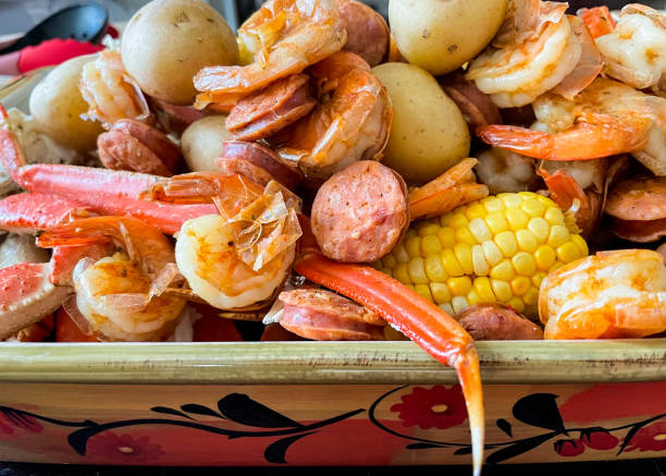 Low Country Boil Steamed Shrimp, crab legs, sausage, potatoes, corn on the cob. boiling stock pictures, royalty-free photos & images