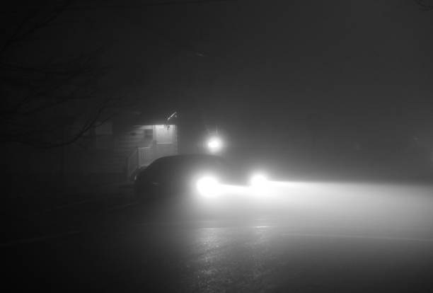 Car headlight in a very dense fog in the night.