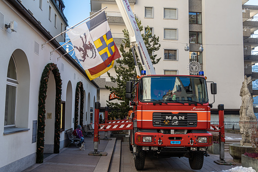 St. Moritz, Switzerland - November 26, 2020: A red fire truck is involved in decorating the city for Christmas