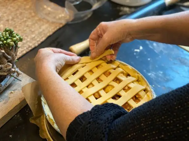Woman is Preparing and making Dutch apple pie for new years eve