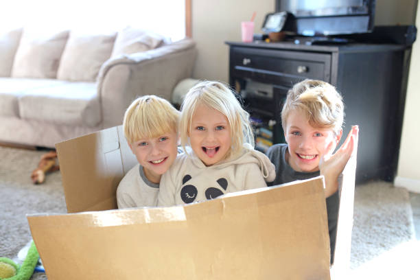 istock Happy Little Kids Playing in Cardboard Box 1293930293