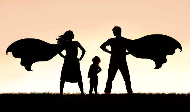 Photo of Silhouette of Superhero Mother and Father with Small Child