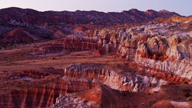 Red and Purple Landscape in Grand Staircase Escalante National Monument Drone shot of the stunning landscape around Catstair Canyon in Grand Staircase Escalante National Monument at sunset. grand staircase escalante national monument stock pictures, royalty-free photos & images